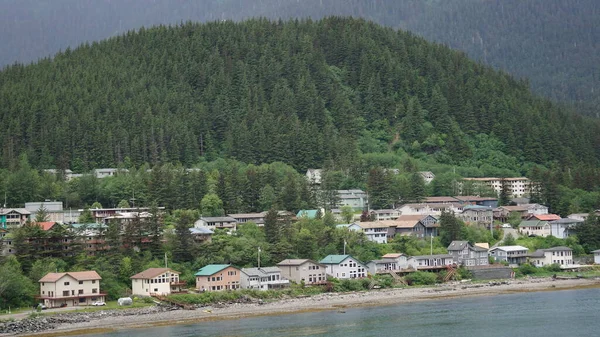 wooden houses at the foot of the mountains by the sea in Juneau, Alaska, United States