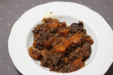 kırmızı şarapta havuç ve sığır eti yanakları servis edilir.