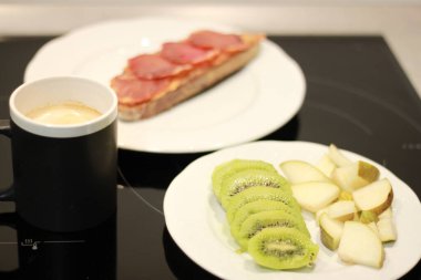 Taze meyveli sağlıklı kahvaltı, domatesli tost ve iberikolu kahve ve sütlü kahve.