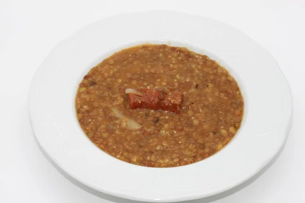 Bir tabak pişmiş sucuklu mercimek.