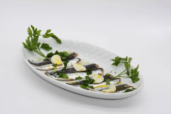 pickled marinated anchovies on a white tray
