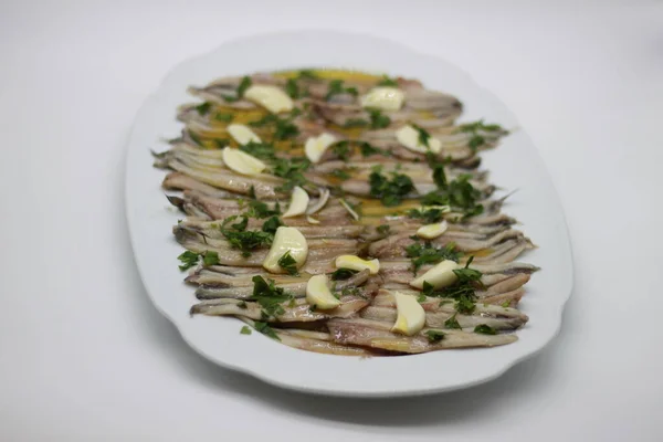pickled marinated anchovies on a white tray