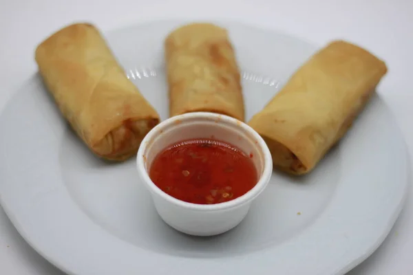 BAAN THAI ROLLS.Rolls filled with mushrooms, vegetables, eggs and minced pork with sweet and sour sauce. Thai street food