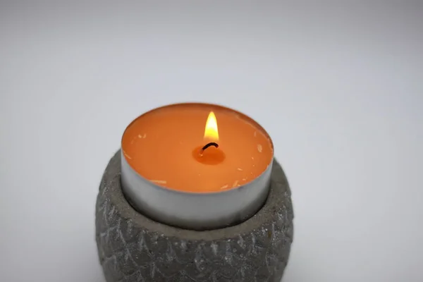 burning scented candle on white background