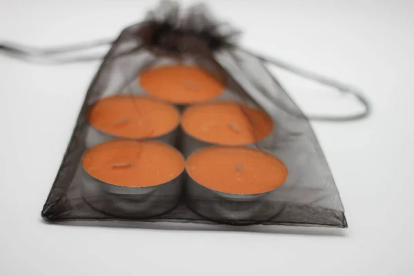 black gift bag with orange scented candles