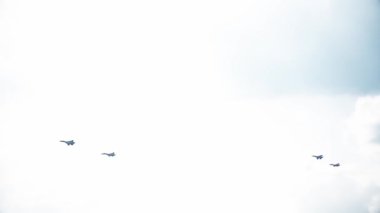 Four fighter jets in the blue sky. A general plan. Aerobatic figures. Airshow. 14 seconds