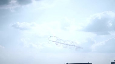 Three fighter jets in the blue sky. A general plan. Aerobatic figures. Airshow. 13 seconds