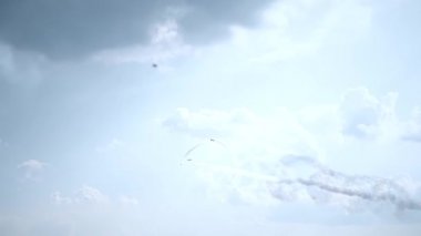 Three fighter jets in the blue sky. A general plan. Aerobatic figures. Airshow. 13 seconds