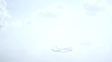 Five fighter jets in the blue sky. Blue, red and white colors. A general plan. Aerobatic figures. Airshow. 10 seconds