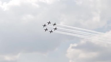 Six fighter jets in the blue sky. A general plan. Aerobatic figures. Airshow. 7 seconds