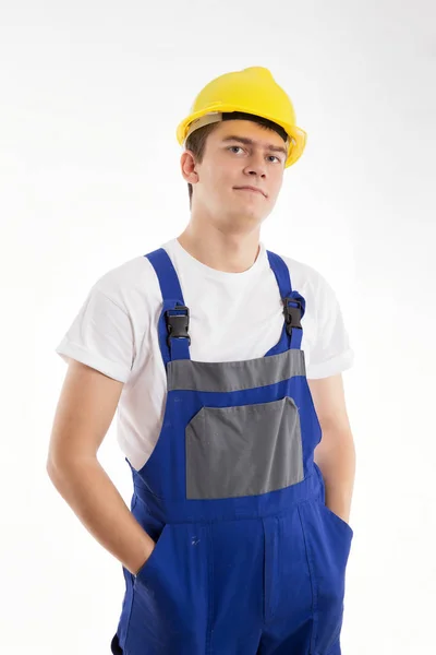 Builder stående i en blå kostym på vit bakgrund — Stockfoto