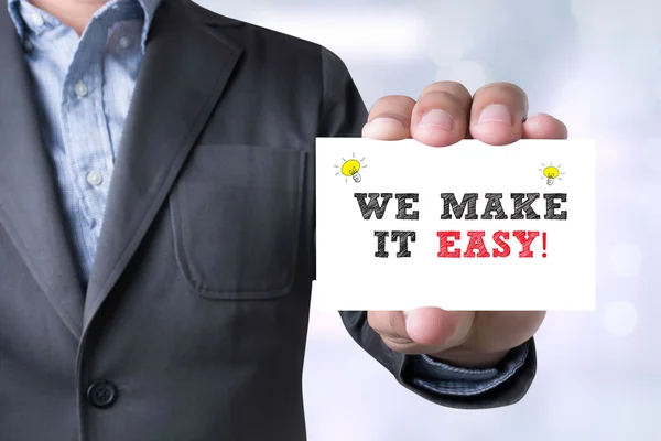 Businessman WE MAKE IT EASY!  message on the card shown — Stock Photo, Image