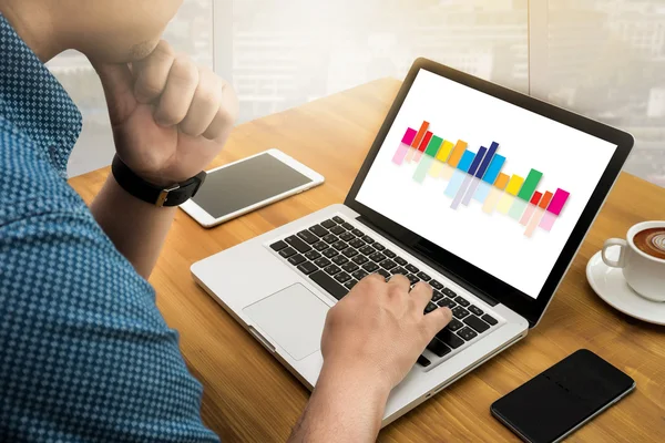 Business team hands at work with financial reports and a laptop — Stock Photo, Image