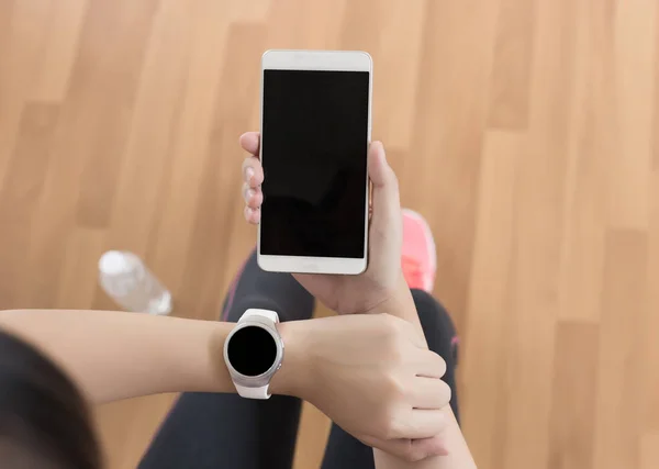 woman use phone  fitness exercise in gym smart gadgets and sport