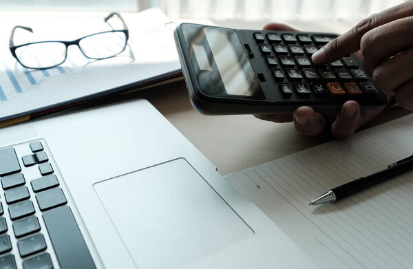 Close up businessman using calculator on documents Unrecognizabl