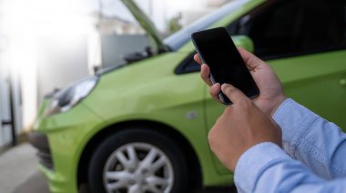 man Using a mobile phone call to  assistance Help with a broken 