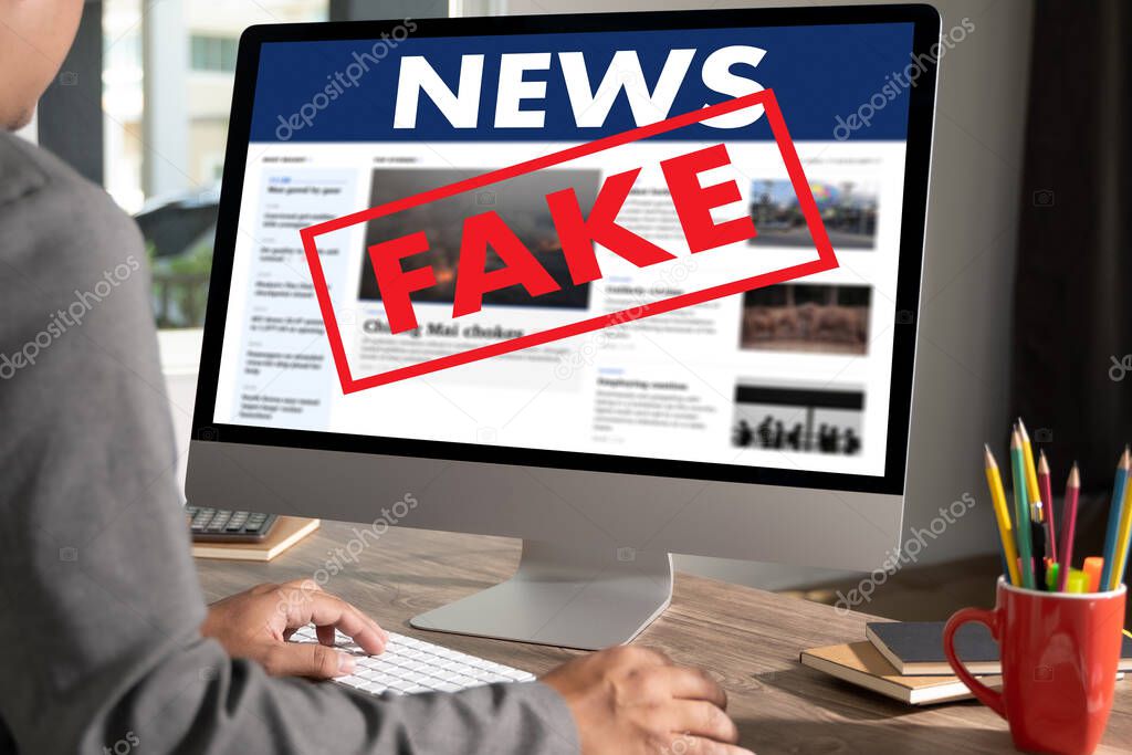 Fake news Young man using laptop Daily News Journal Update  Fake news
