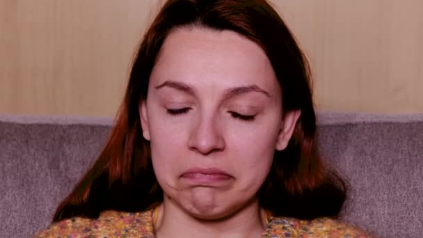 Close-up of a young woman watching a sad and emotional movie. — Stock Video