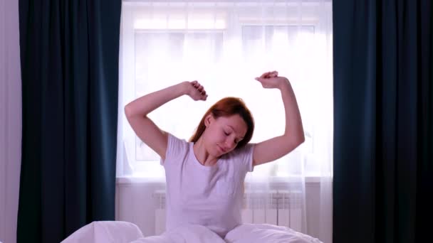 Kızıl saçlı kadın yataktan kalkıp geriniyor. Yavaş çekim — Stok video