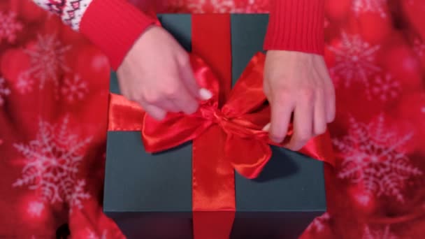 Top view of an young woman is opening a gift box arrived at home. Concept of holidays and new year. — Stock Video