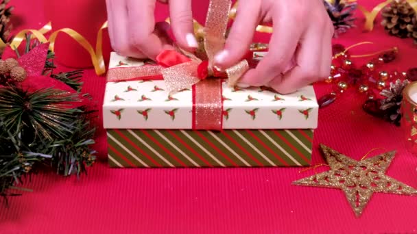 Feche a mão da mulher e decorar caixa de presente de Natal. Conceito de embrulho e desembalagem. Conceito de férias e Ano Novo. celebração de férias de inverno . — Vídeo de Stock
