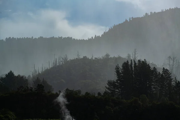 Rain over forest mountains. Misty mountain landscape hills at rainy day.