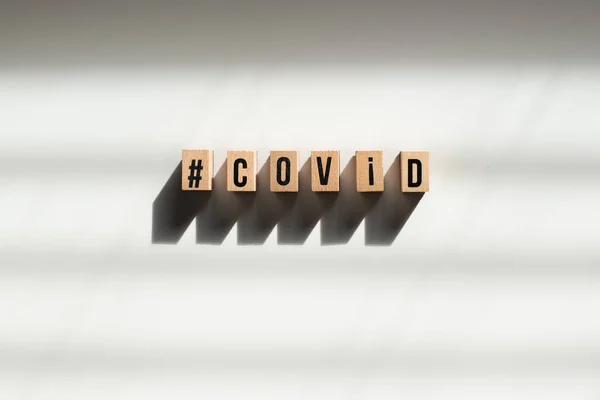 Covid Text Made Wooden Cube White Background Shadow — стоковое фото
