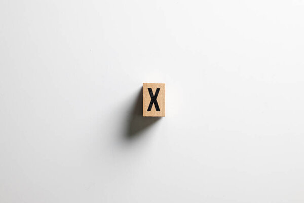 " X "text made of wooden cube on White background with clipping path
.