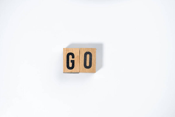 " GO " text made of wooden cube on  White background.