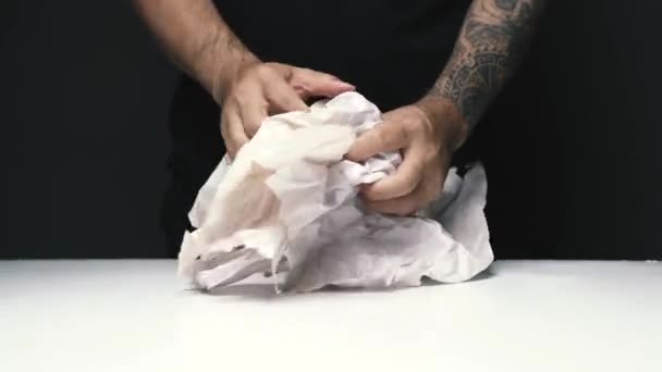 Man Hand Met Tattoo Knijpen Papier Boven Witte Tafel Donkere — Stockvideo