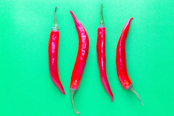 Red chilli on green background — Stock Photo, Image