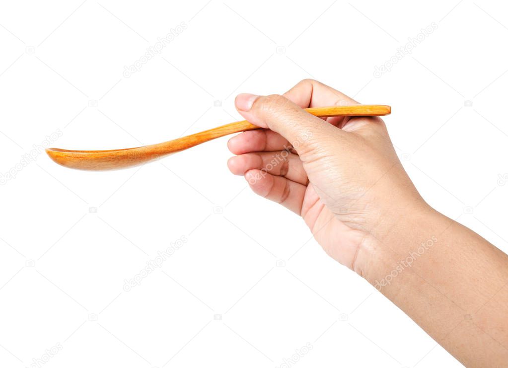 Male hand holding an empty wooden spoon.