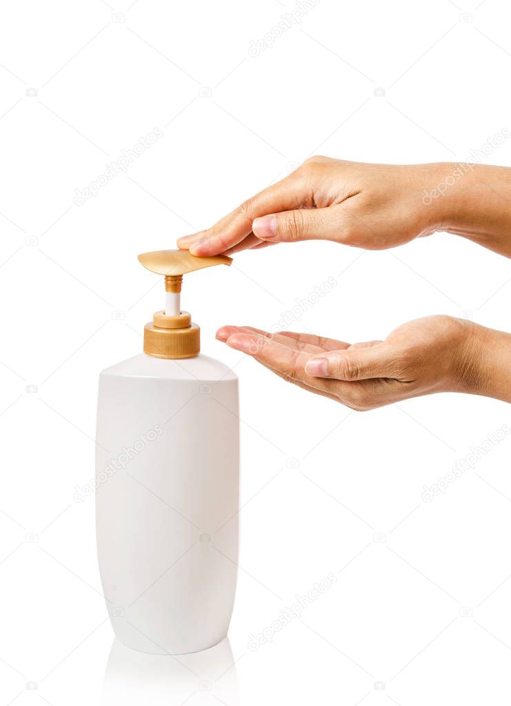Female hands pushing pump bottle.
