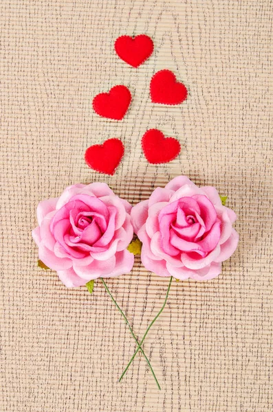 Pink rose and red heart. — Stock Photo, Image