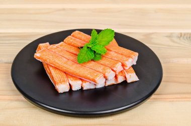 Crab Stick in black dish. clipart