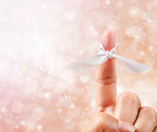 Hand with white ribbon. Stock Photo