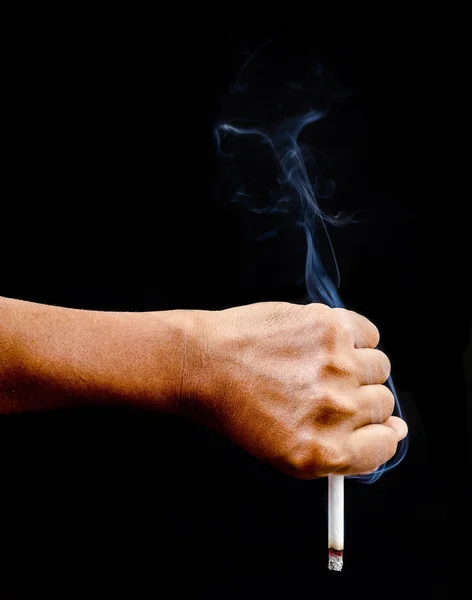 Upside down man hand holding a cigarette with smoke. — Stock Photo, Image