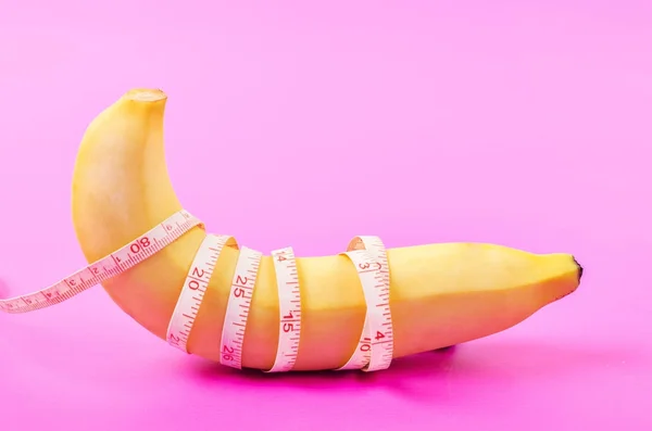 Beautiful banana with measuring tape. — Stock Photo, Image