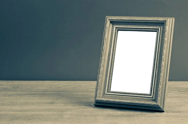 Vintage photo frame on wooden table. — Stock Photo, Image