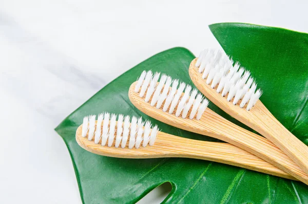 Bamboo Toothbrushes Green Leaves Marble Background Zero Waste Concept — Stock Photo, Image