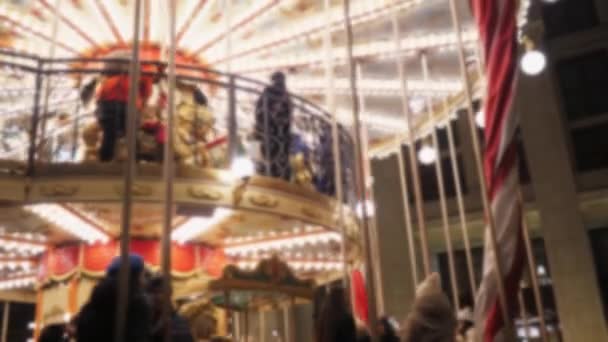 Bright carousel with lights and horses rolls the children. Christmas background. — Stock Video