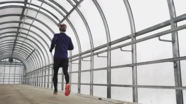 Running Man In Sportswear Workout Before Triathlon, Sprinting In Glass Tunnel. 