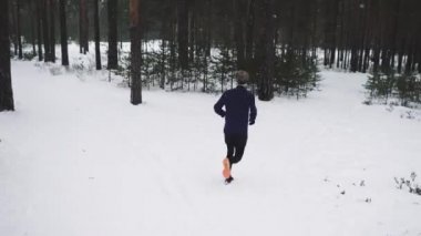 Running Man In Sportswear Workout Before Triathlon. Winter Sports Concept