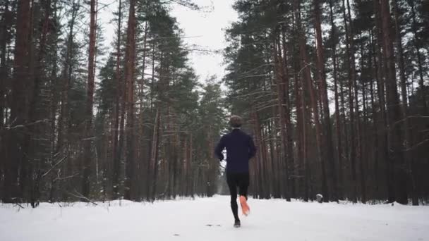 Hombre corriendo en entrenamiento de ropa deportiva antes del triatlón. Concepto de deportes de invierno — Vídeos de Stock