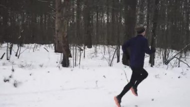 Running Man In Sportswear Workout Before Triathlon. Winter Sports Concept