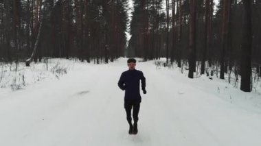 Running Man In Sportswear Workout Before Triathlon.Winter Sports Concept. Aerial