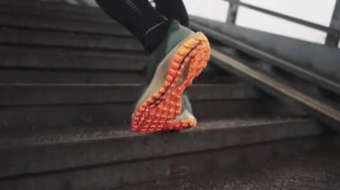 man athlete legs running up stairs training intense cardio in tunnel slow motion