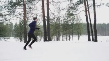 Running Man In Sportswear Workout Before Triathlon. Winter Sports Concept