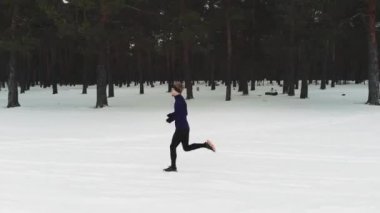 Running Man In Sportswear Workout Before Triathlon.Winter Sports Concept. Aerial