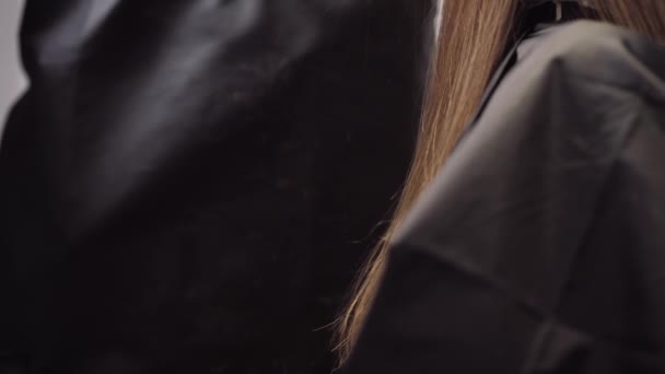 El cabello cae en el marco durante el proceso de corte de pelo. Peluquería chica cortes de pelo. Primer plano 4K cámara lenta — Vídeos de Stock